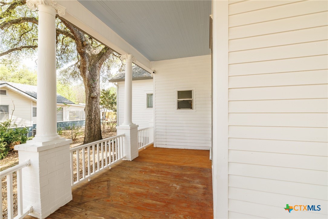 604 St Michael Street Gonzales, TX 78629 - Photo 5 of 37 a view of a porch with wooden floor and fence