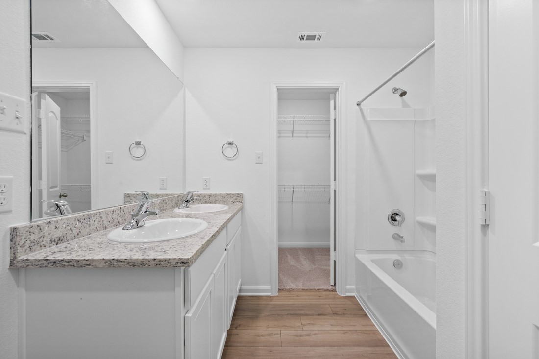 120 Morrison Drive Jarrell, TX 76537 - Photo 5 of 11 The primary bathroom includes granite countertops, double vanities, enclosed water closet and a walk-in closet.