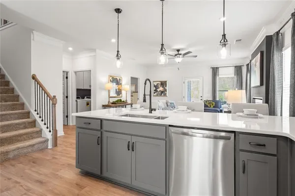 a kitchen with kitchen island a sink stove and refrigerator with wooden floor