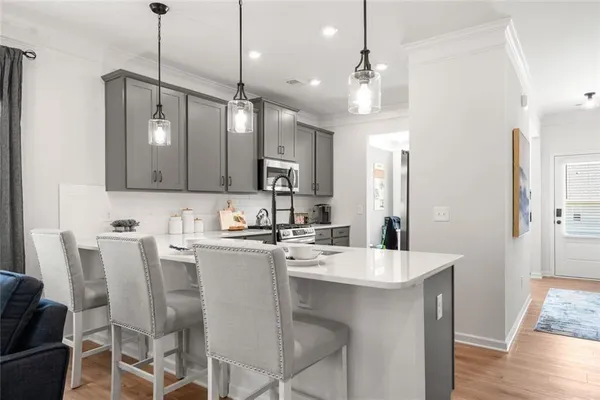 a kitchen with a stove a sink and a microwave