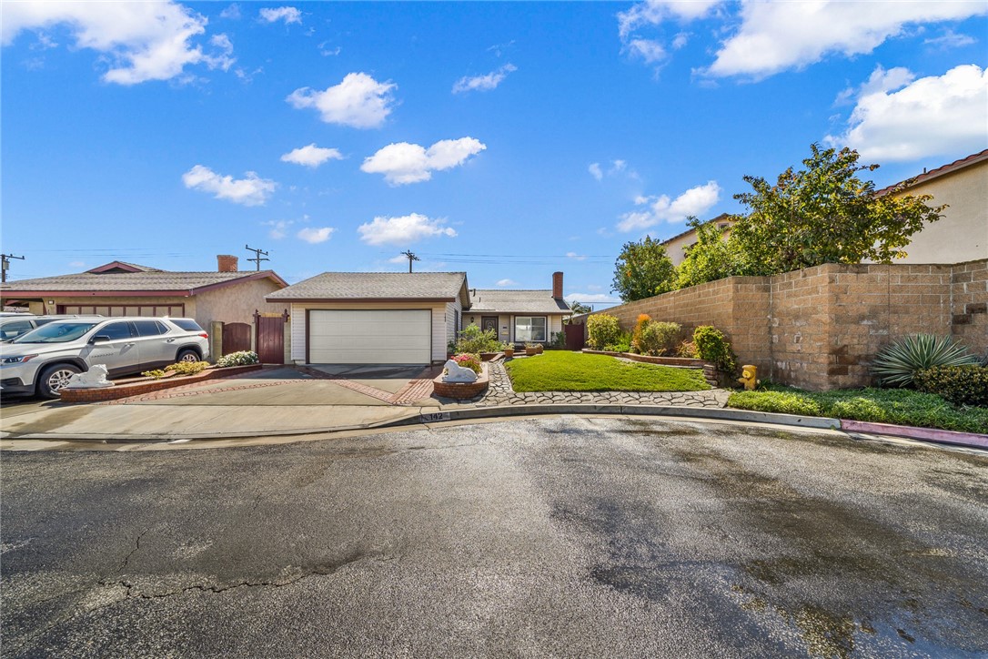 a view of a car parked in front of a house with a yard