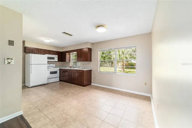 a kitchen with a cabinets and white appliances