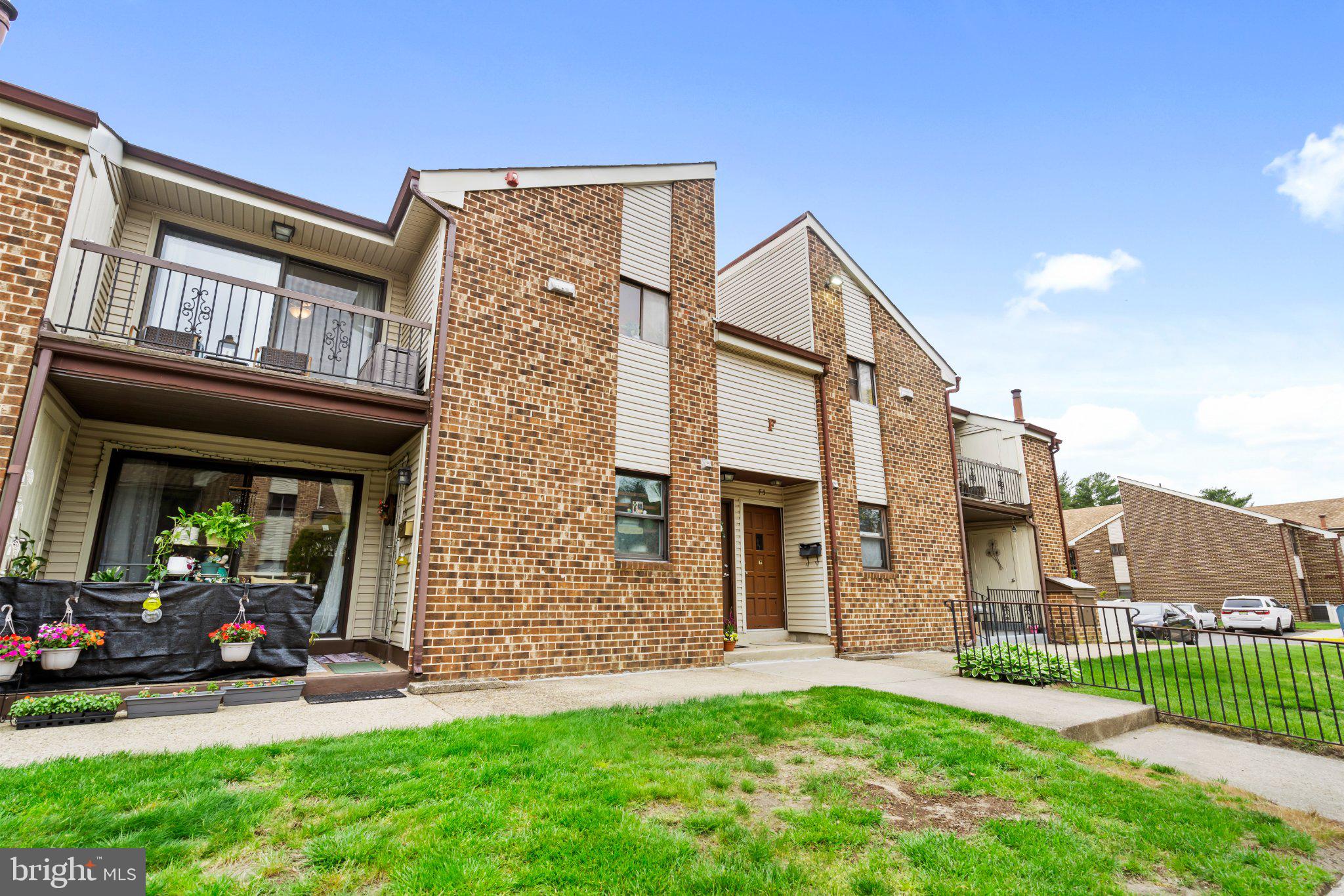 1475 Mt Holly Road, Unit F2 Edgewater Park, NJ 08010 - Photo 2 of 32 Charming brick facade with lush greenery.