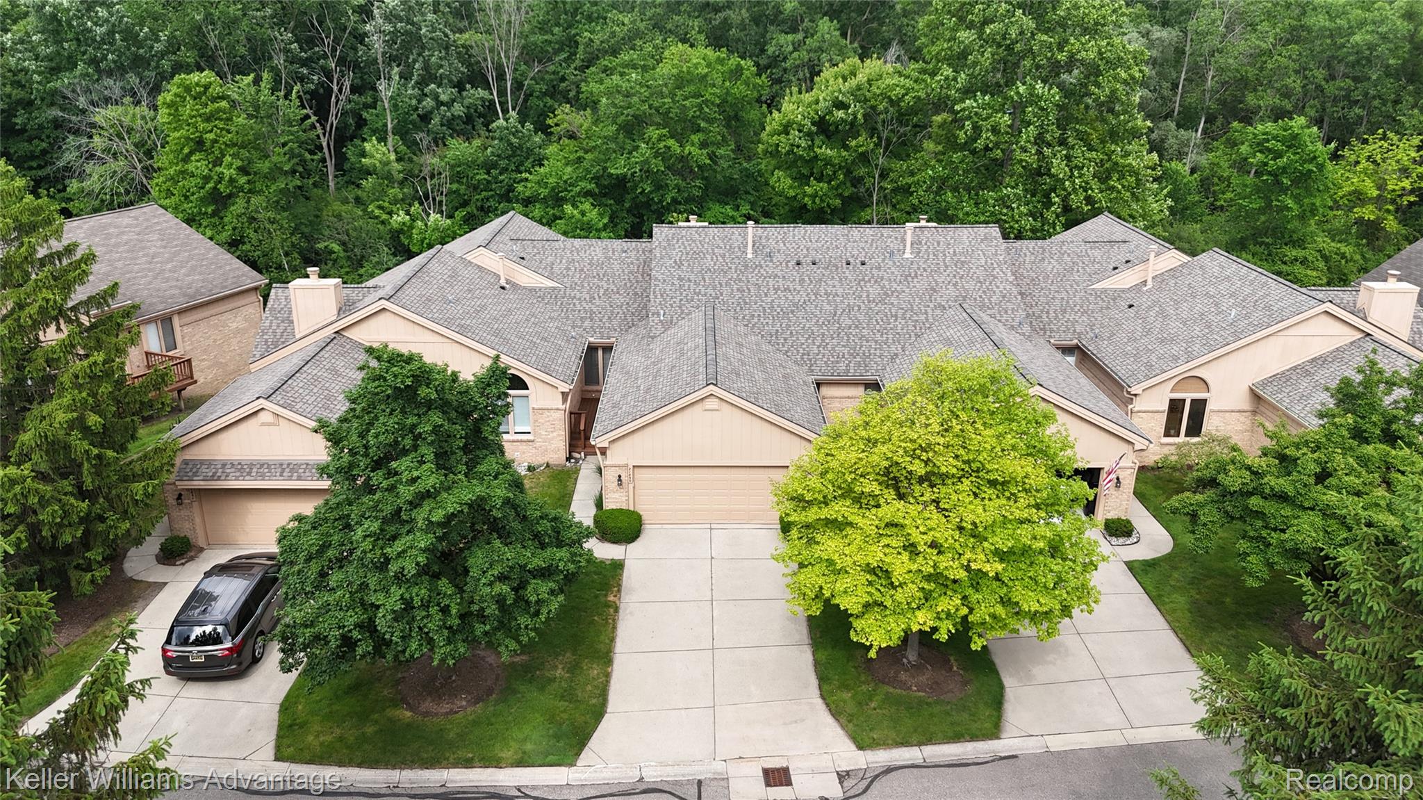 21850 River Ridge Trail Farmington, MI 48335 - Photo 1 of 33 Multiple attached residences featuring tan siding, gabled roofs, and mature landscaping