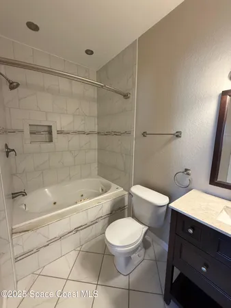 a bathroom with a toilet a sink a mirror and bathtub