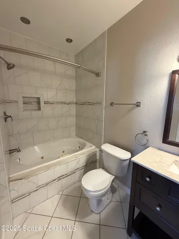 a bathroom with a toilet a sink a mirror and bathtub