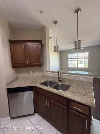 a kitchen with granite countertop cabinets sink and window
