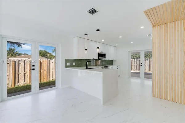 a view of kitchen with stainless steel appliances refrigerator oven