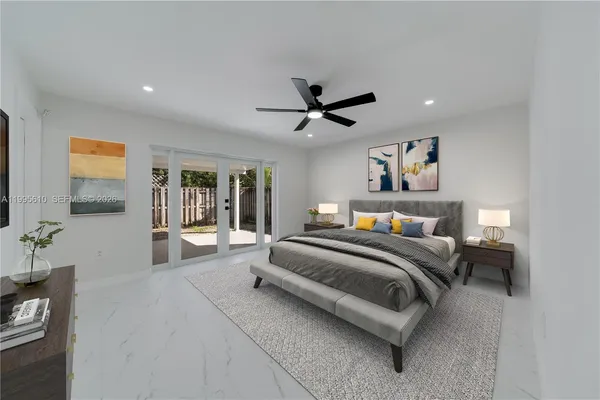 a spacious bedroom with a bed and a chandelier