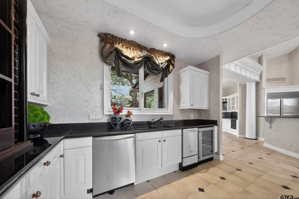 a kitchen with cabinets and window
