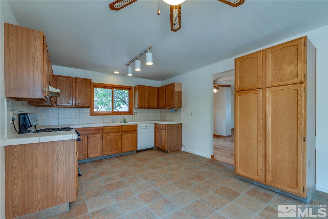 200 Gooseberry Drive Reno, NV 89523 - Photo 12 of 25 a kitchen with stainless steel appliances granite countertop a refrigerator and a stove top oven