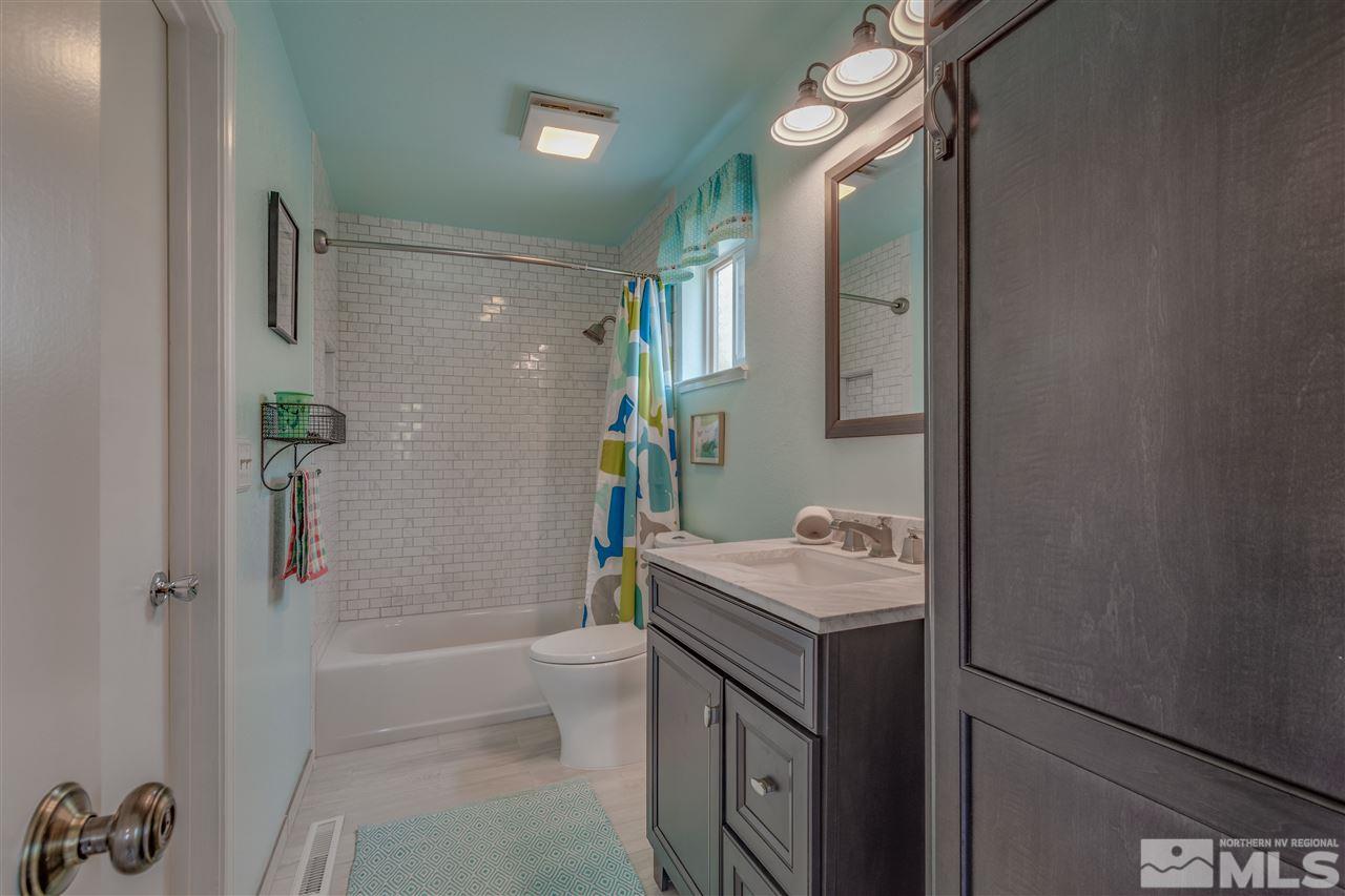 200 Gooseberry Drive Reno, NV 89523 - Photo 13 of 25 a bathroom with a sink vanity granite tub shower and a mirror