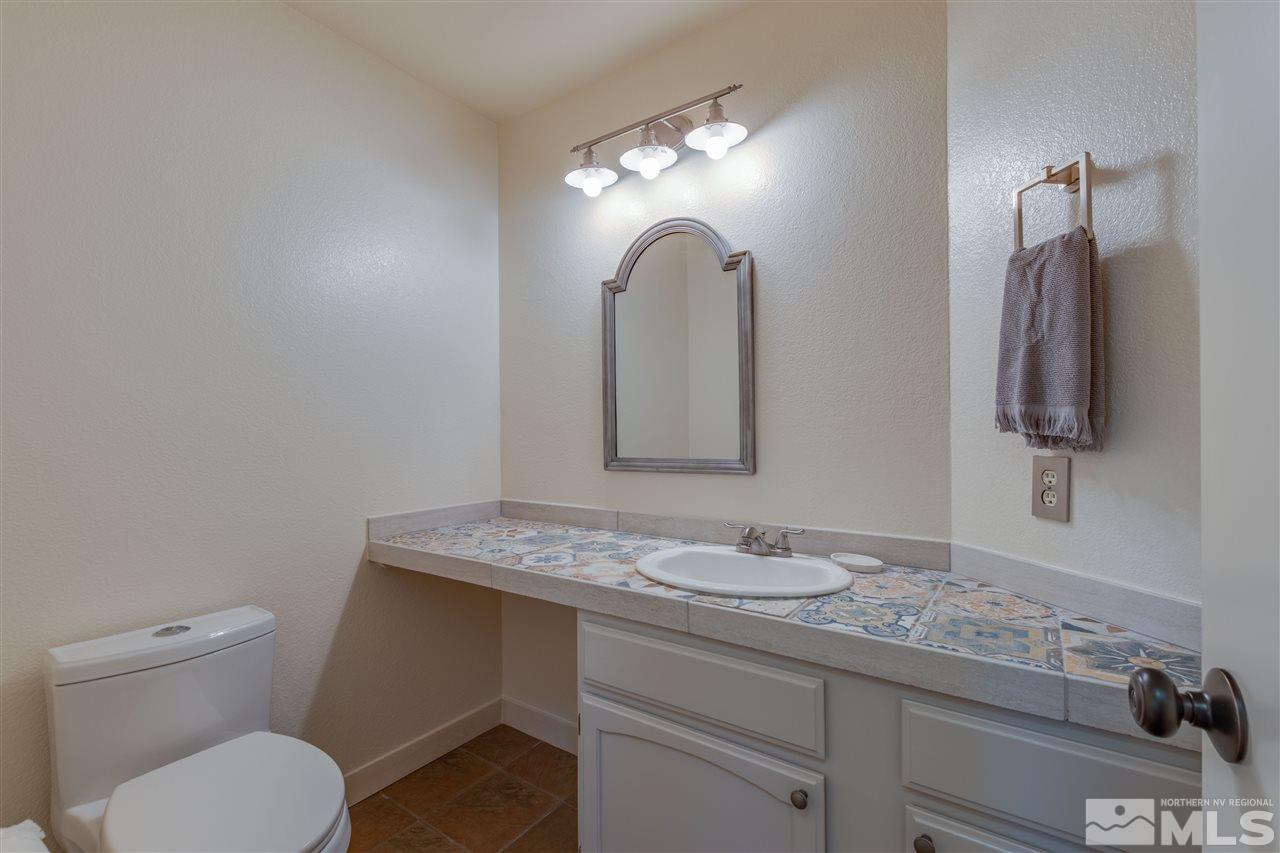 200 Gooseberry Drive Reno, NV 89523 - Photo 14 of 25 a bathroom with a granite countertop toilet sink and mirror