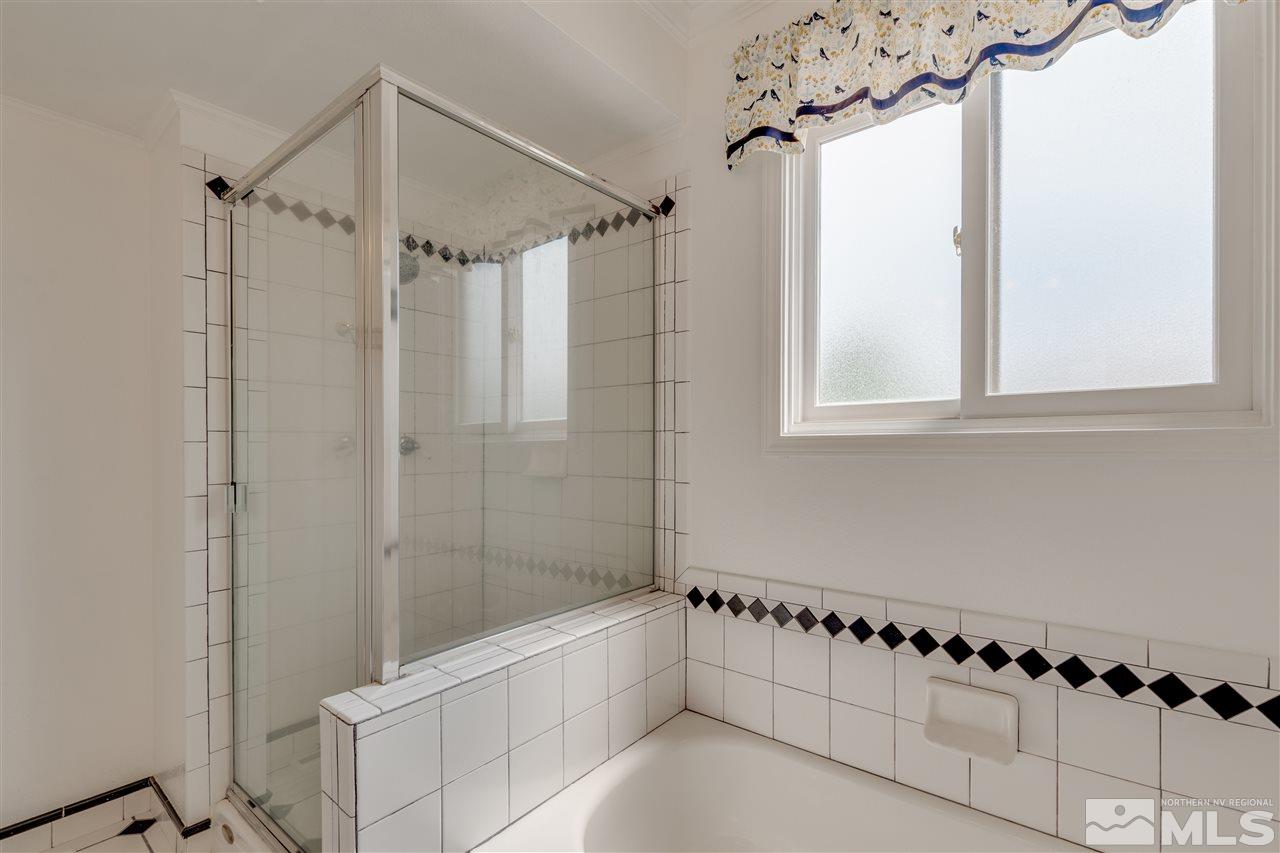 200 Gooseberry Drive Reno, NV 89523 - Photo 16 of 25 a bathroom with a bathtub a shower and a window
