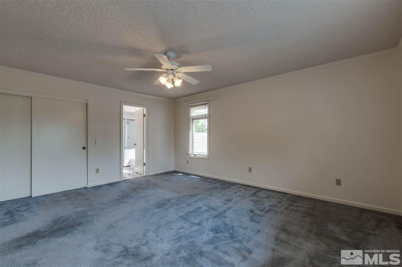 200 Gooseberry Drive Reno, NV 89523 - Photo 24 of 25 an empty room with a ceiling fan and windows