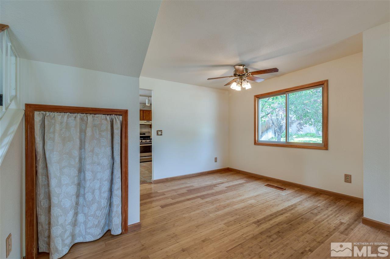 200 Gooseberry Drive Reno, NV 89523 - Photo 10 of 25 an empty room with wooden floor chandelier fan and windows
