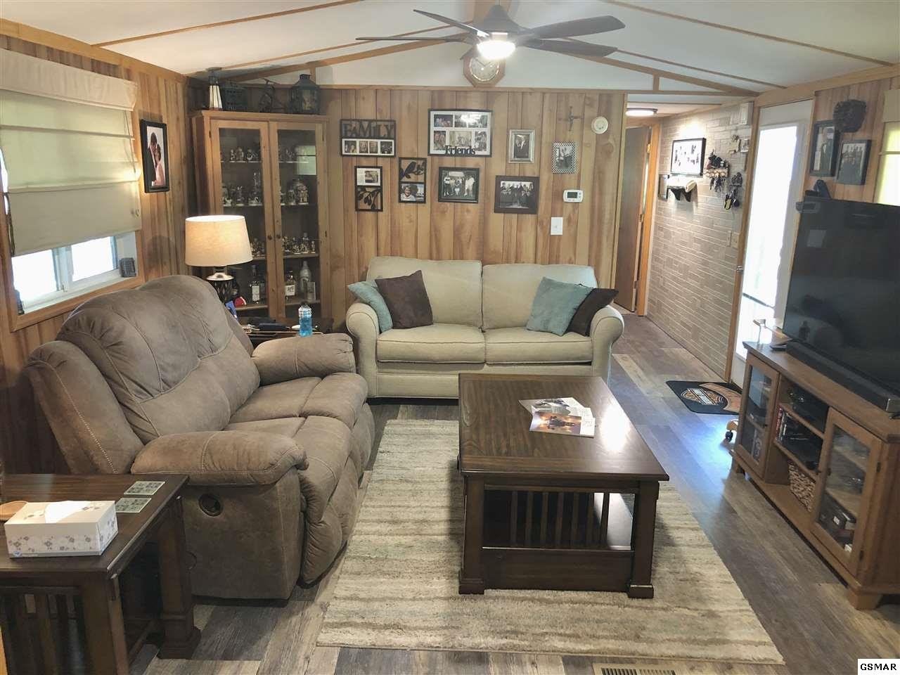 1403 Lin Creek Road Sevierville, TN 37876 - Photo 5 of 24 a living room with furniture and a flat screen tv