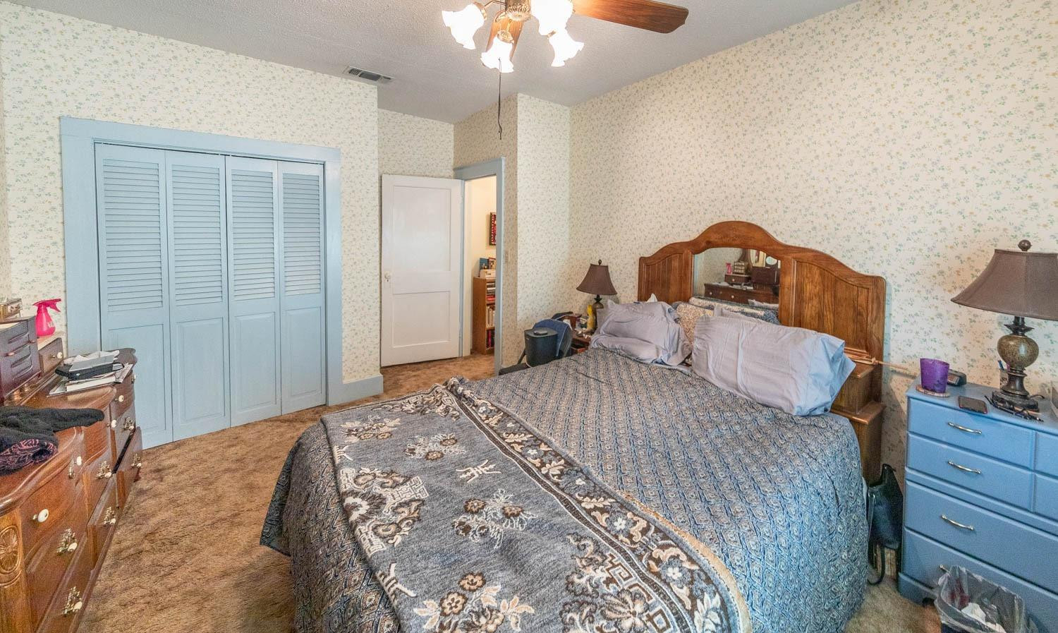632 FM 3269 Muleshoe, TX 79347 - Photo 5 of 48 a bedroom with a bed and a chandelier