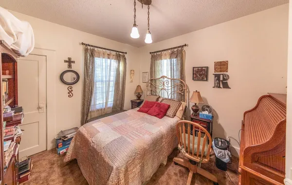 a bedroom with bed and a window
