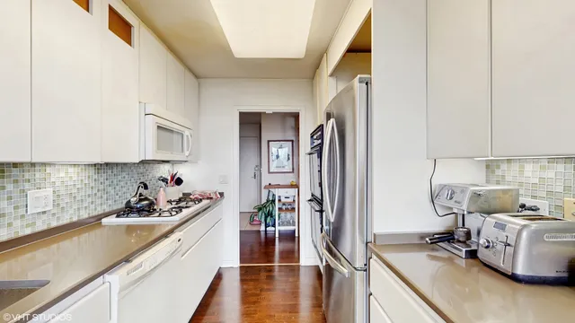 a bedroom with furniture and a large window