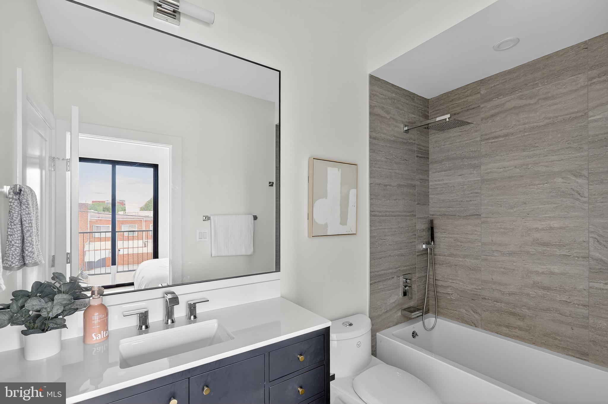 828 21st Street Northeast, Unit 2 Washington, DC 20002 - Photo 13 of 27 a bathroom with a double vanity sink mirror double and bathtub