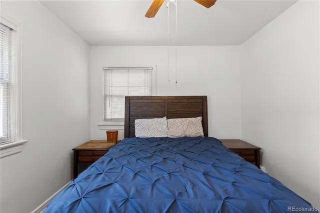 a bedroom with a bed and painting on the wall