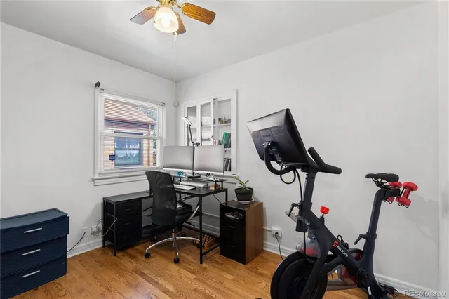 a view of a workspace with furniture and a window