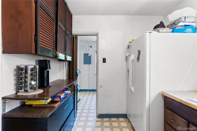 a kitchen with stainless steel appliances granite countertop a refrigerator and a stove