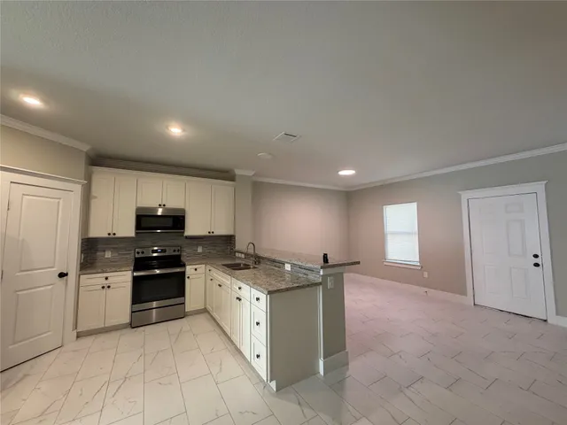 a kitchen with stainless steel appliances granite countertop a sink and cabinets