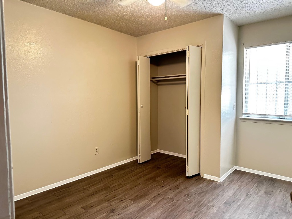 1102 Hickory Grove Drive, Unit B Austin, TX 78753 - Photo 11 of 14 an empty room with wooden floor and closet