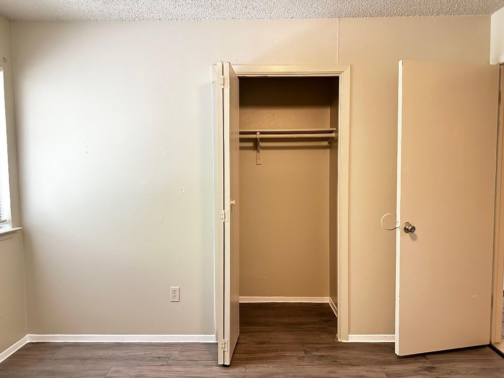 1102 Hickory Grove Drive, Unit B Austin, TX 78753 - Photo 12 of 14 a view of an empty room with wooden floor and closet