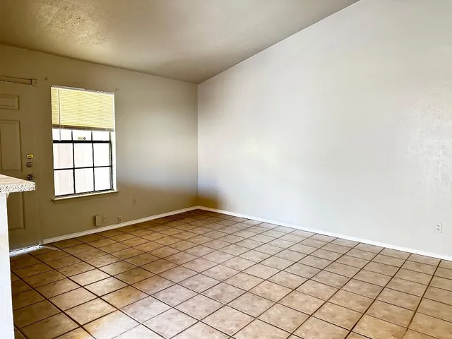 a view of a kitchen with a sink and a window