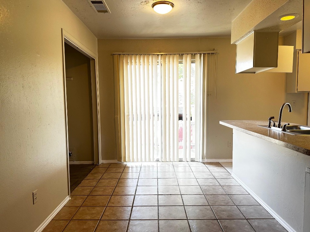 1102 Hickory Grove Drive, Unit B Austin, TX 78753 - Photo 4 of 14 a view of a kitchen with a sink and a window