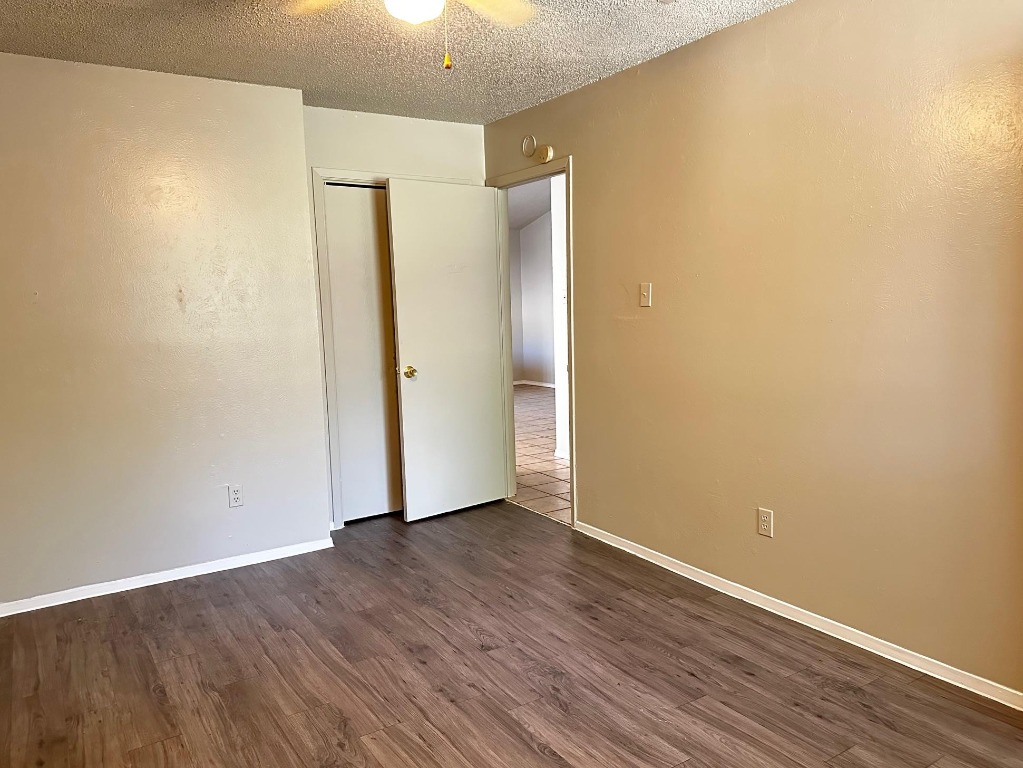 1102 Hickory Grove Drive, Unit B Austin, TX 78753 - Photo 8 of 14 a view of an empty room with wooden floor