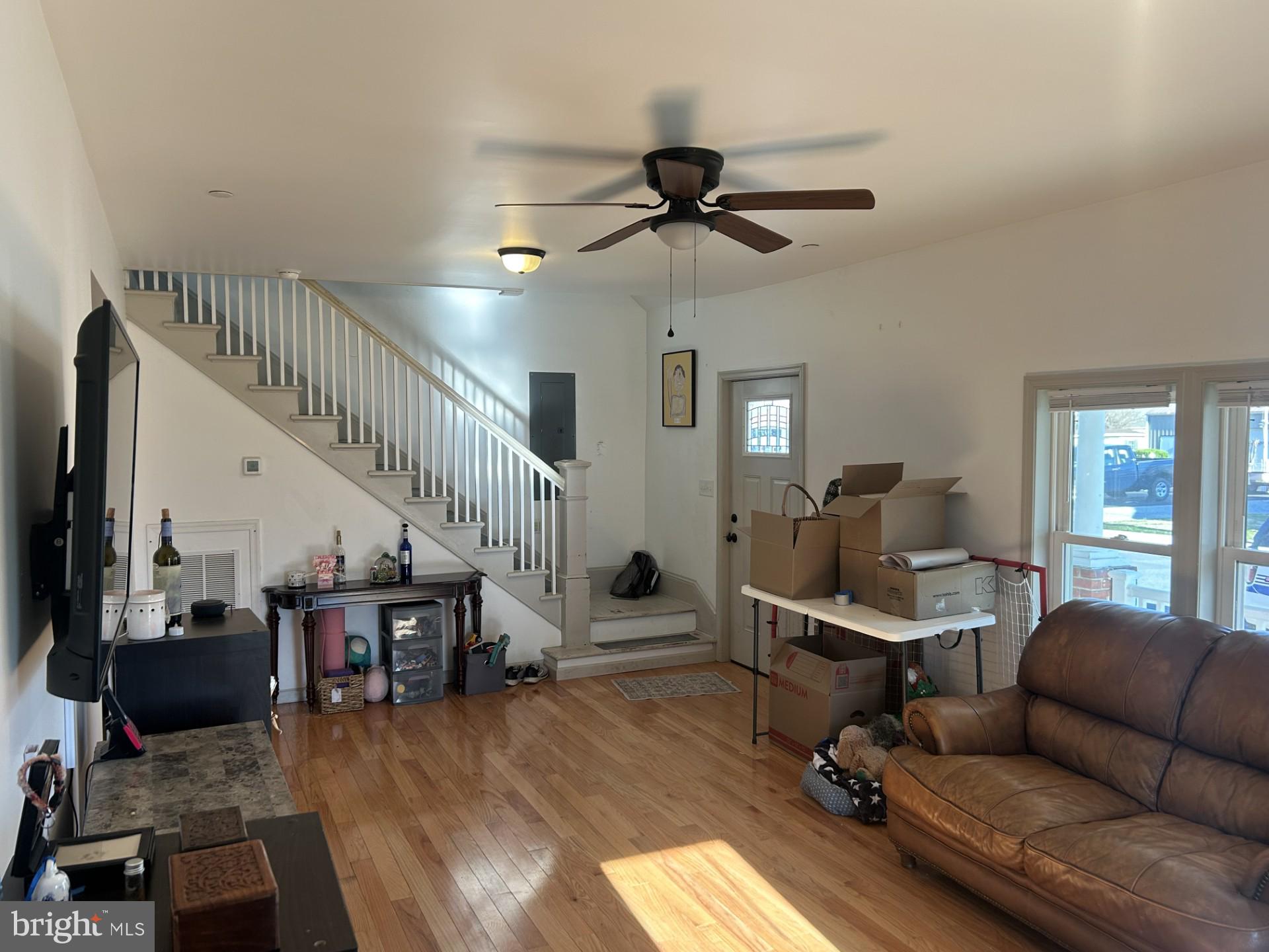 404 Phillips Avenue Cambridge, MD 21613 - Photo 4 of 6 a workspace with wooden floor and windows