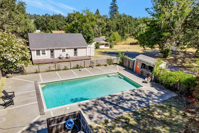 an aerial view of a house with a big yard