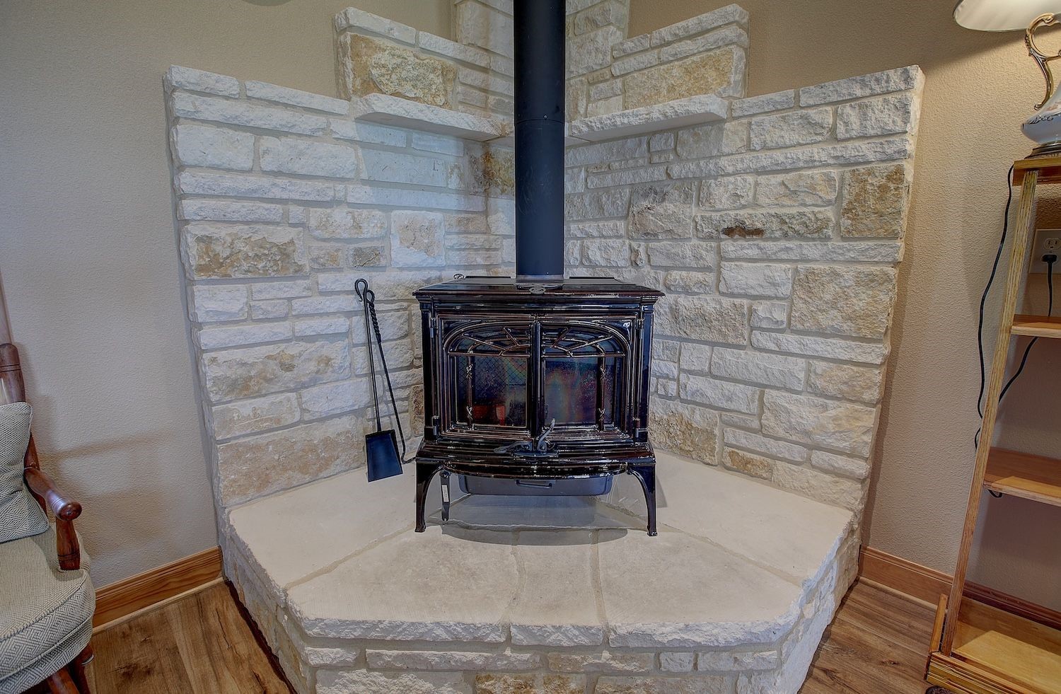 9414 Laird Road Round Top, TX 78954 - Photo 20 of 50 Close up of wood-burning pot belly stove with stone surround