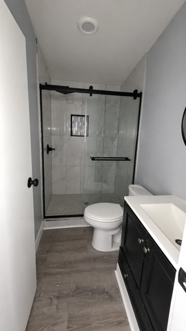 1450 North Dixie Downs Road, Unit 51 St. George, UT 84770 - Photo 11 of 25 Bathroom featuring a walk-in shower with a black-framed glass enclosure, white subway tile walls, and a recessed niche