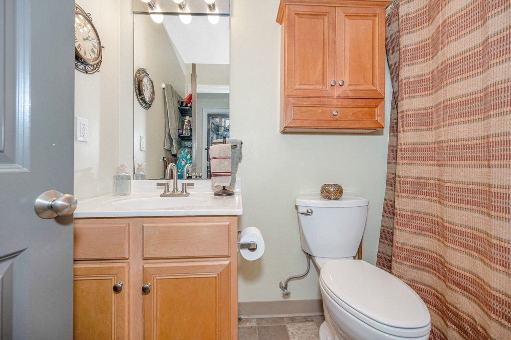 200 Market Street, Unit 3409 Lowell, MA 01852 - Photo 12 of 21 a white toilet sitting next to a bathroom sink
