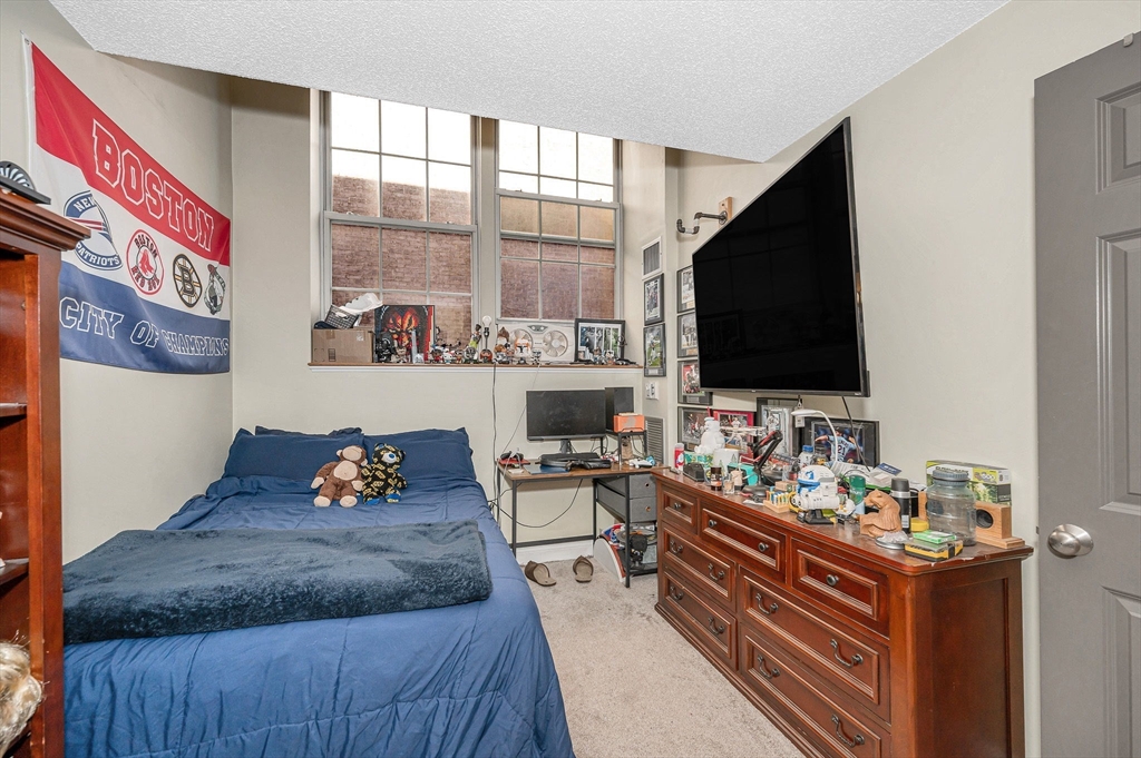 200 Market Street, Unit 3409 Lowell, MA 01852 - Photo 14 of 21 a living room with furniture and a flat screen tv