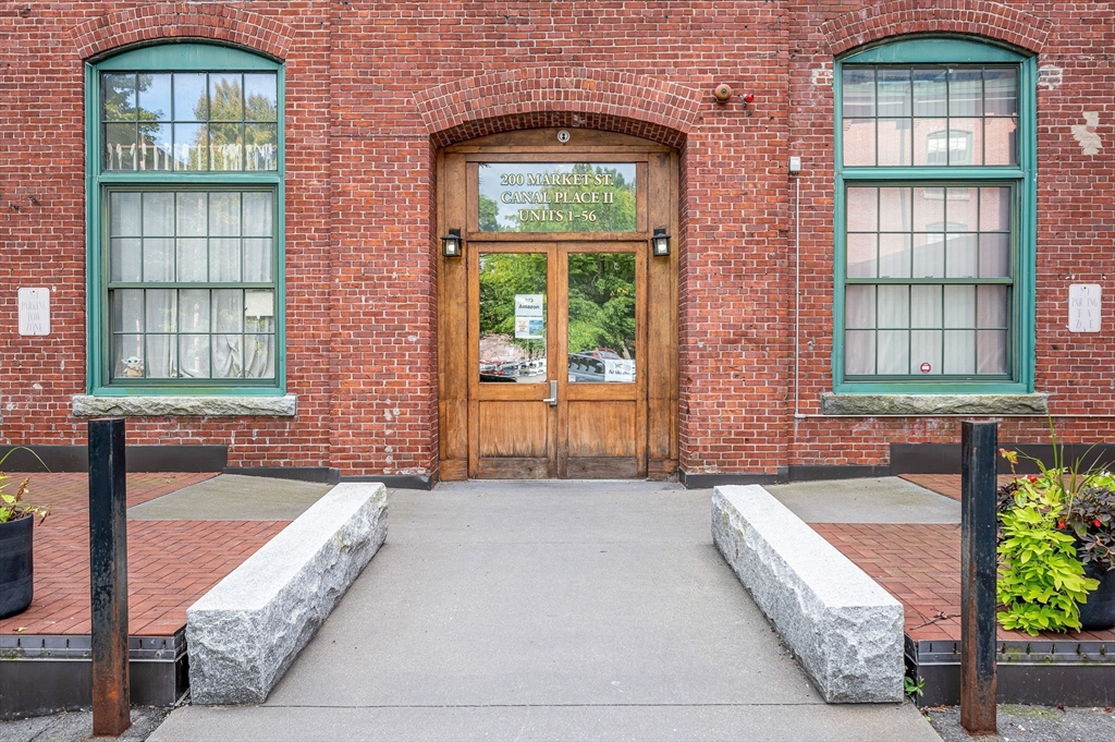 200 Market Street, Unit 3409 Lowell, MA 01852 - Photo 20 of 21 a front view of a house with a yard