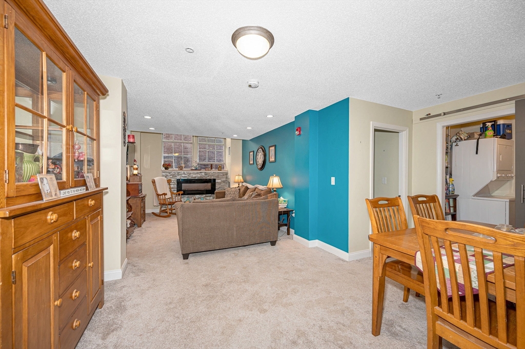 200 Market Street, Unit 3409 Lowell, MA 01852 - Photo 2 of 21 a living room with furniture and a flat screen tv