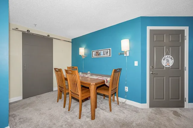 a view of a dining room with furniture and window