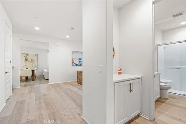 a bathroom with a granite countertop sink mirror toilet and shower