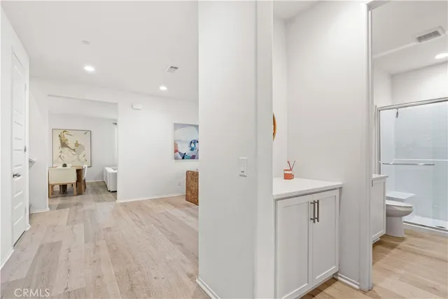 a kitchen with stainless steel appliances kitchen island granite countertop a sink a stove and a wooden floors