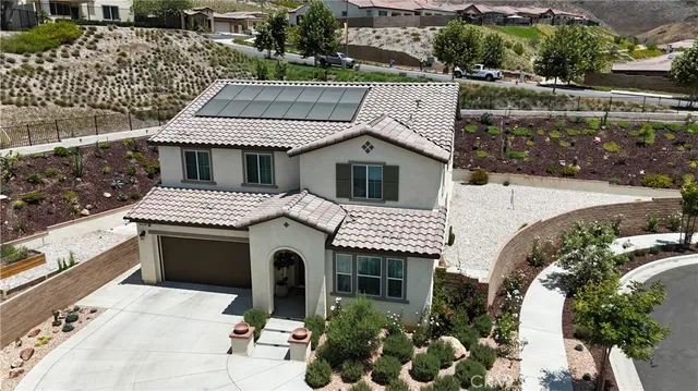 an aerial view of a house with a yard