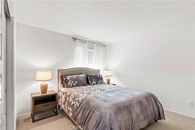 a bedroom with bed and window