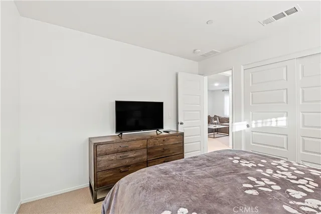 a bedroom with a bed and flat screen tv