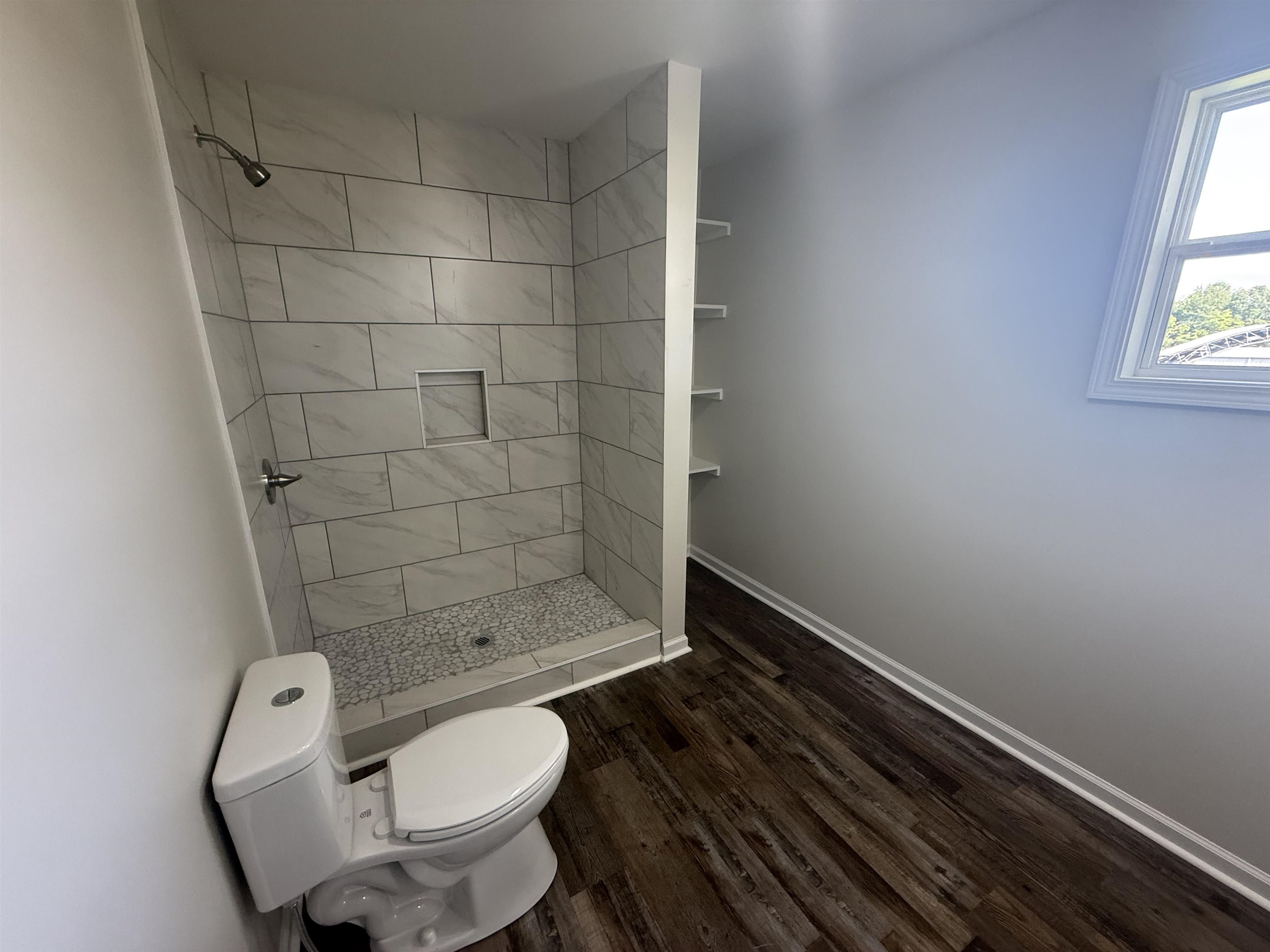 170 Leapwood Road Enville, TN 38332 - Photo 18 of 33 Walk-in shower with large format tile surround and pebble-finish floor