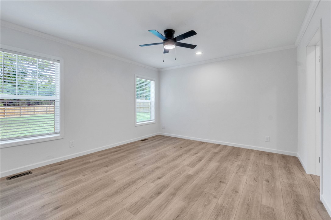 108 Old River Road Iva, SC 29655 - Photo 12 of 31 A quiet space with light wood-look flooring and multiple windows, ready for personalization.